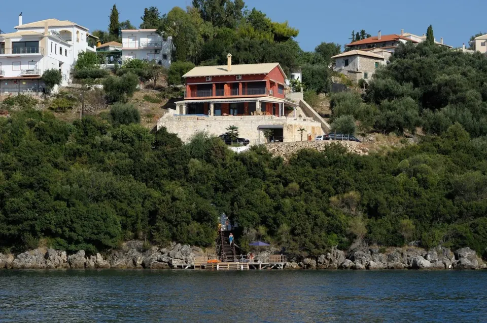 The estate seen from the water: residences on the hillside, private dock below