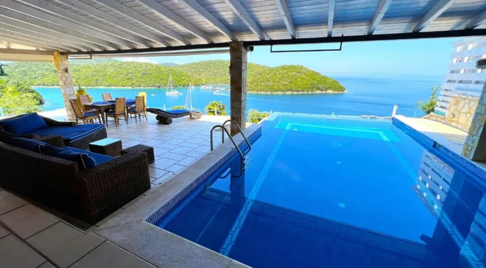 Infinity pool and covered terrace looking across Sivota Bay to the islets
